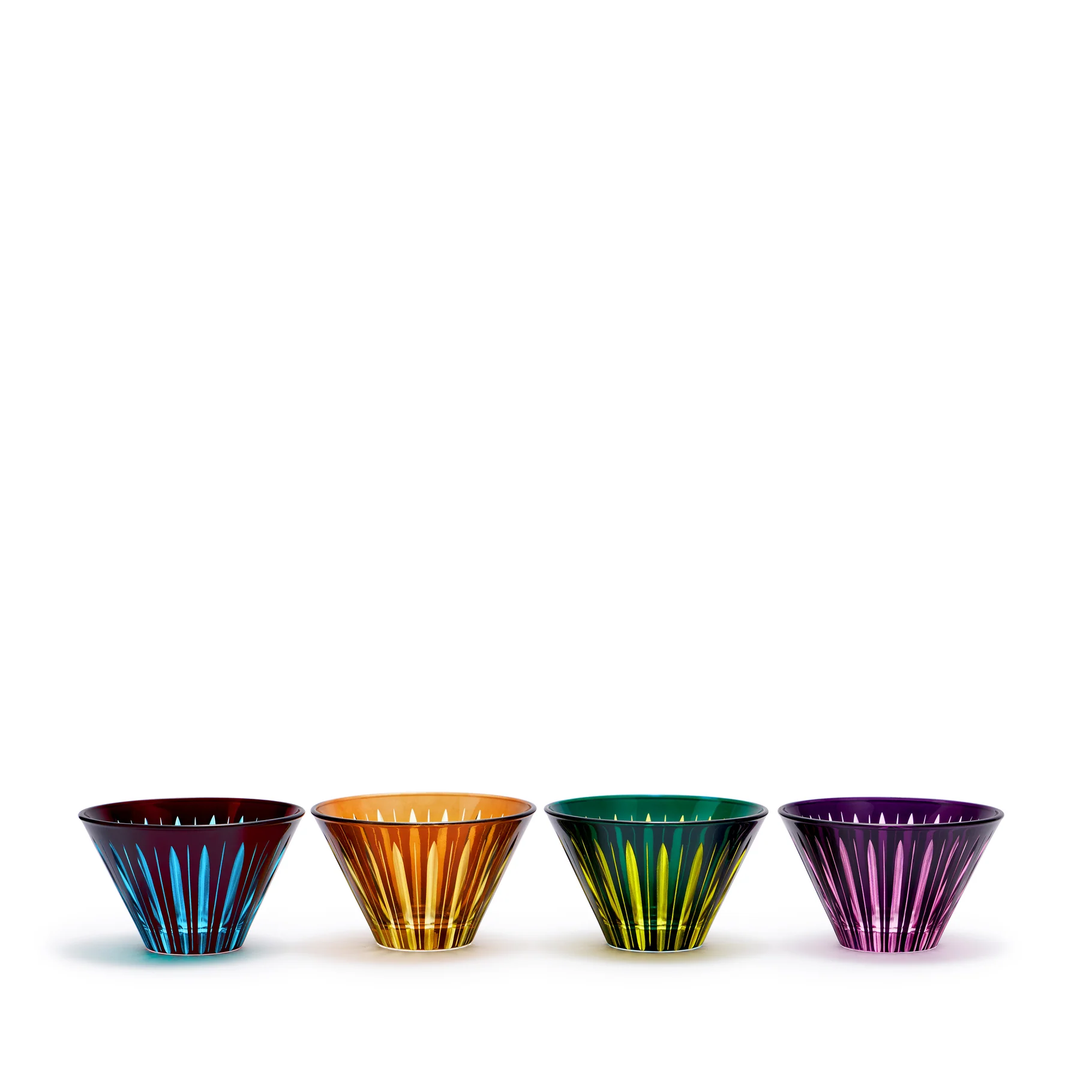Four colorful glass condiment dishes with cut stripes on a white background