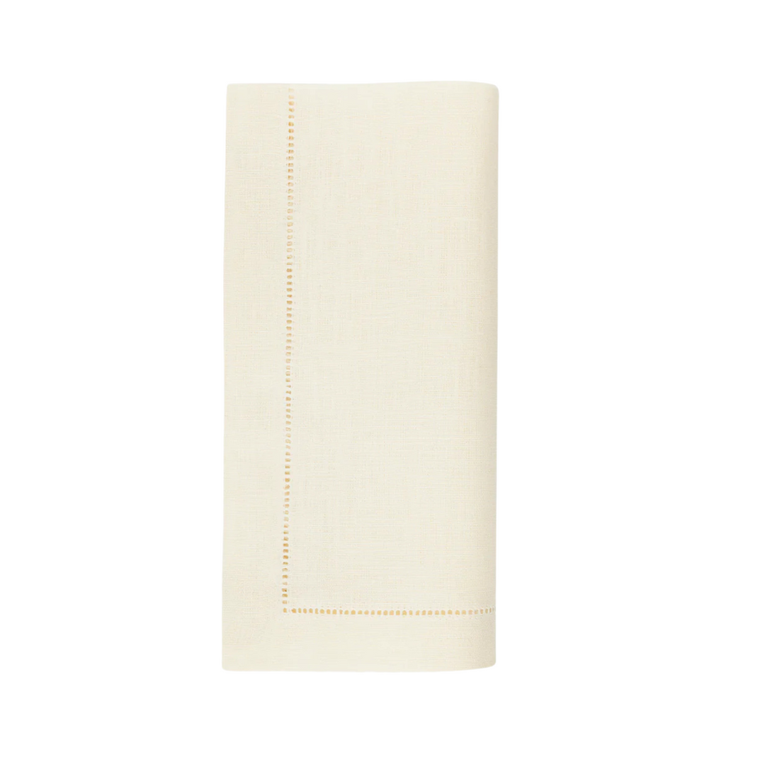 Eggshell-colored napkin with a stitched border on a white background