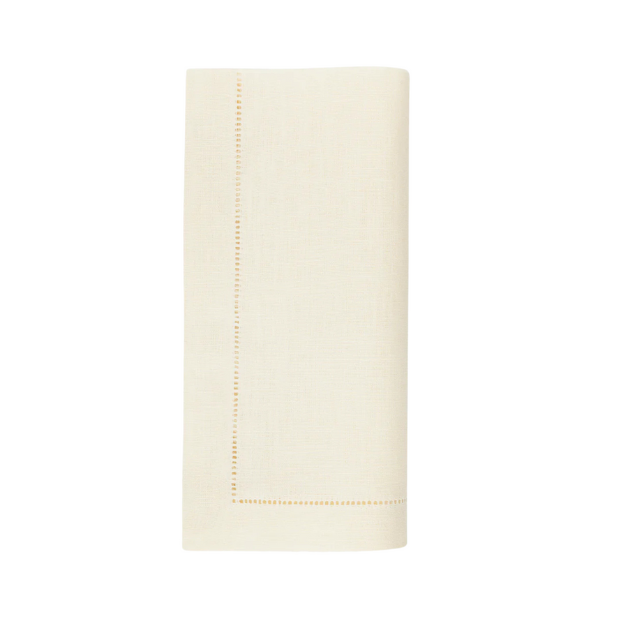 Eggshell-colored napkin with a stitched border on a white background