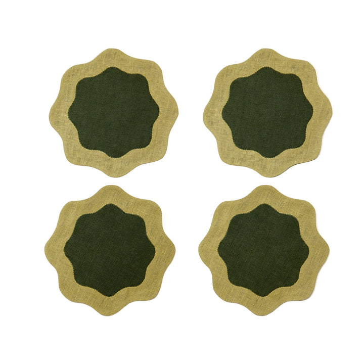 Four green coasters with deeper green centers and wavy edges on a white surface