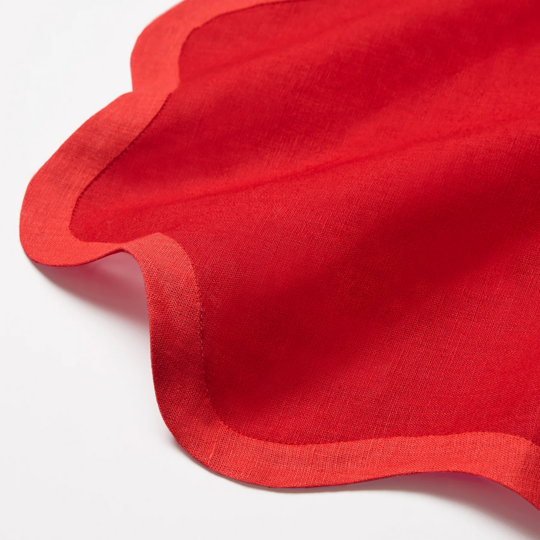 Red cocktail napkin with a wavy edge
