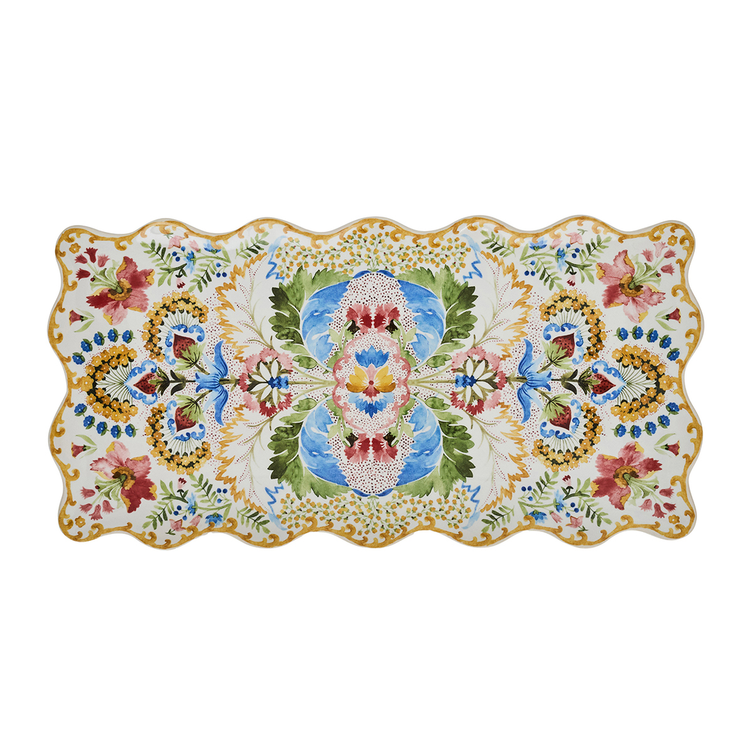 A rectangular ceramic serving platter with a scalloped wavy edge, featuring a green gold pink and blue l floral and ornamental pattern
