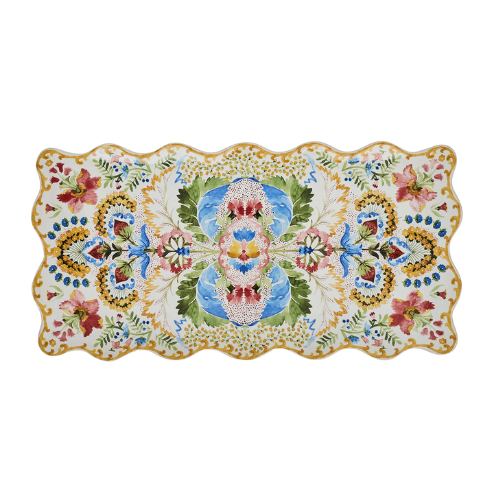 A rectangular ceramic serving platter with a scalloped wavy edge, featuring a green gold pink and blue l floral and ornamental pattern