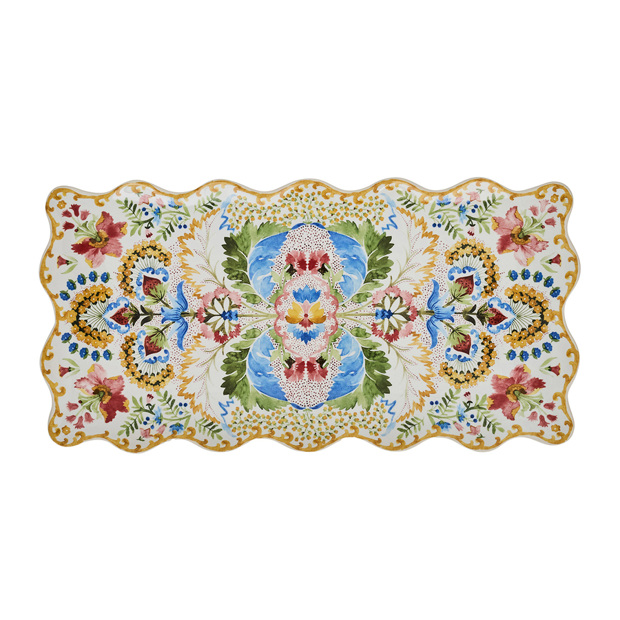 A rectangular ceramic serving platter with a scalloped wavy edge, featuring a green gold pink and blue l floral and ornamental pattern