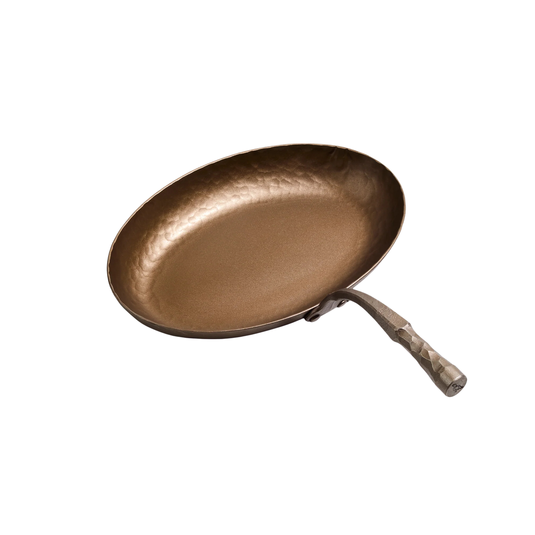 Hammered frying pan with a wooden handle on a white background