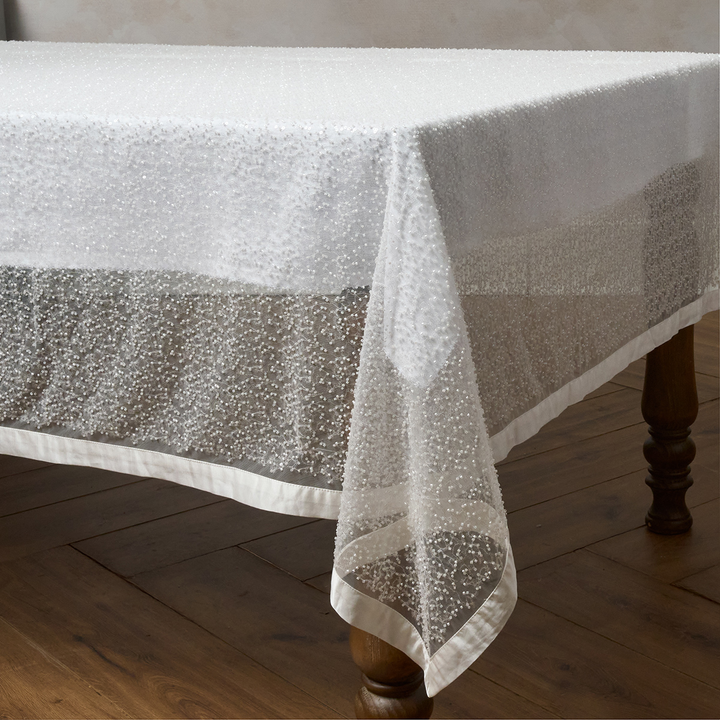 White textured tablecloth on a wooden table
