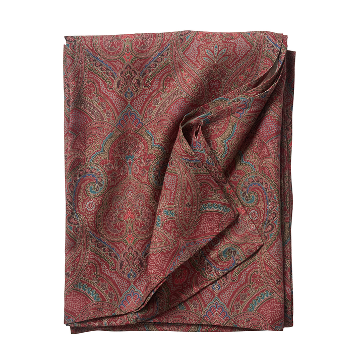 Folded paisley patterned fabric on a white background