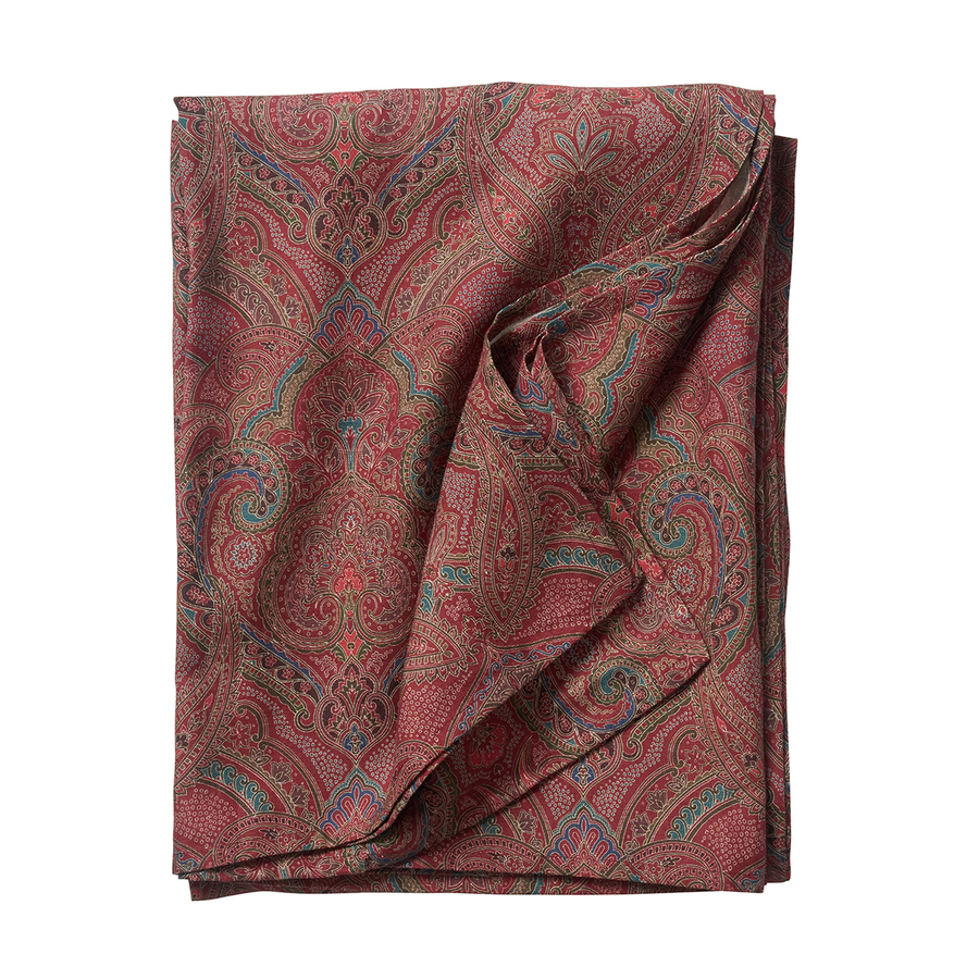 Folded paisley patterned fabric on a white background