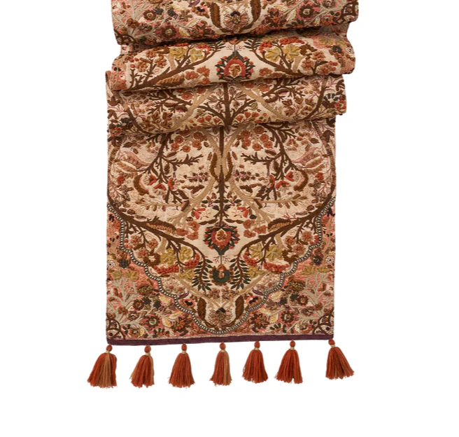 Decorative table runner with intricate fall patterns and tassels 