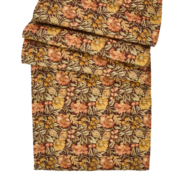 Floral patterned fabric table runner with orange and green and brown colors