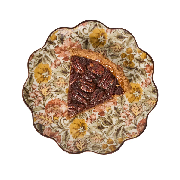 Decorative fall salad plate with a slice of pecan pie on an amber floral patterned background