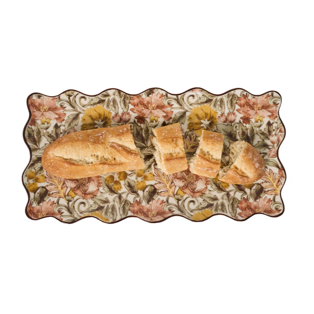 Decorative plate with floral patterns holding bread slices 