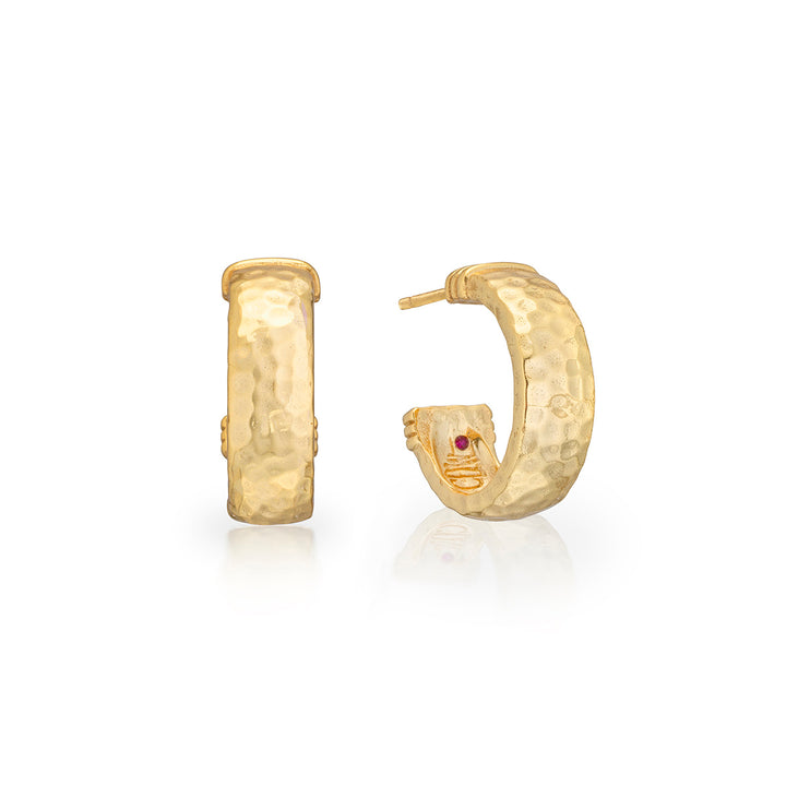 hammered gold hoop earrings with a small red gemstone