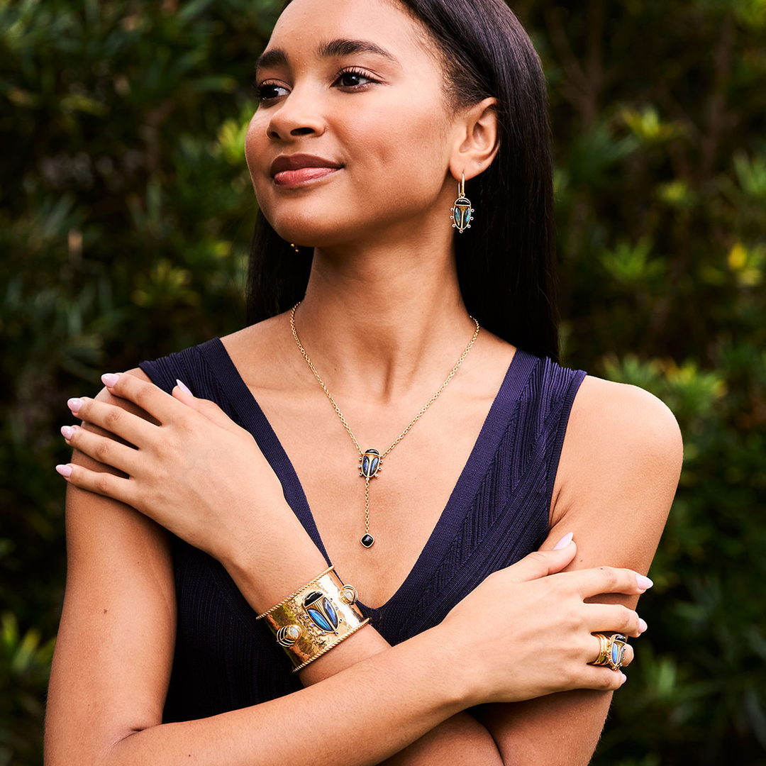 Woman wearing jewelry with a blurred green background