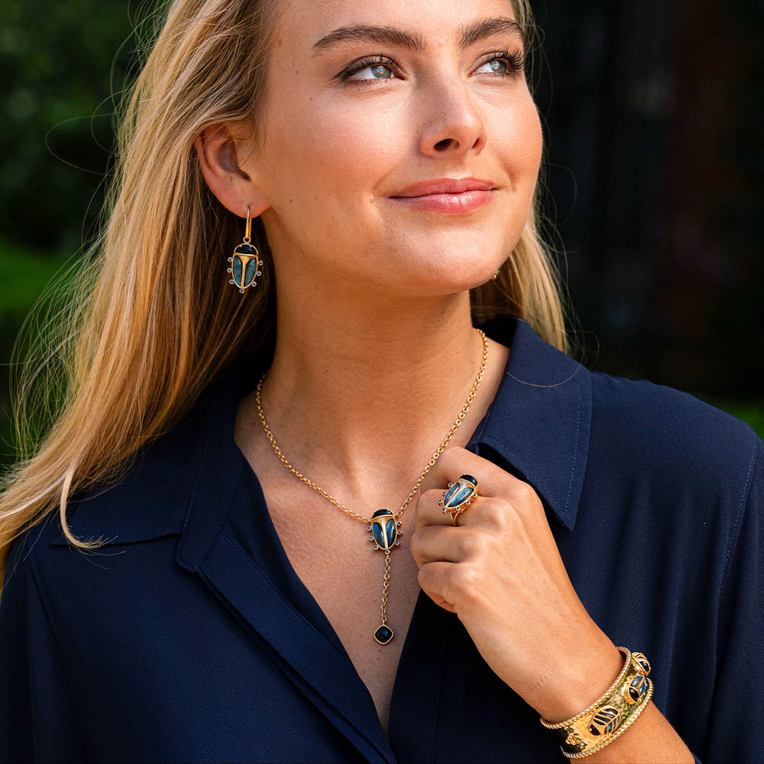 Woman wearing gold jewelry with a dark background