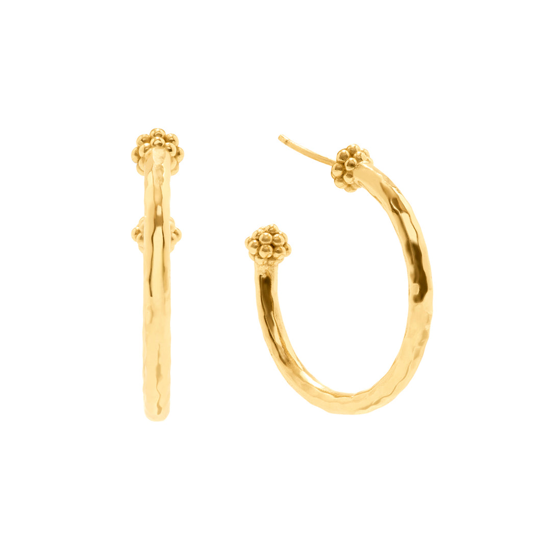 Gold hoop earrings with floral ends on a white background