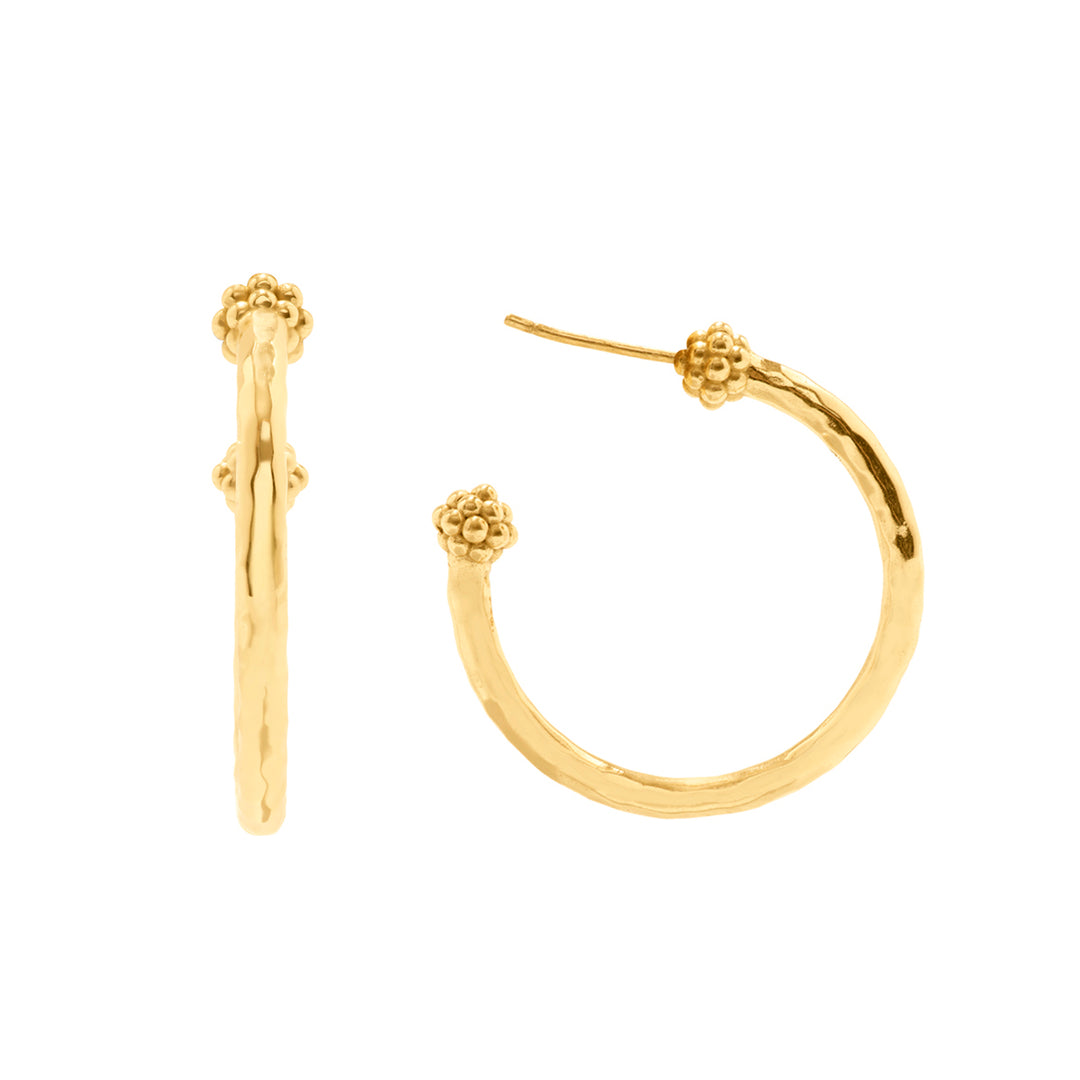 Gold hoop earrings with floral ends on a white background