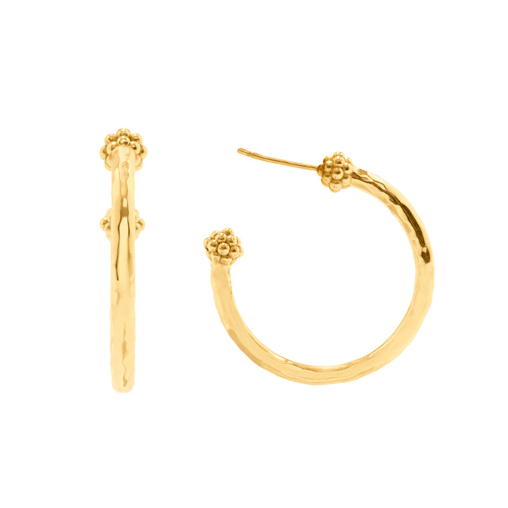 Gold hoop earrings with floral ends on a white background