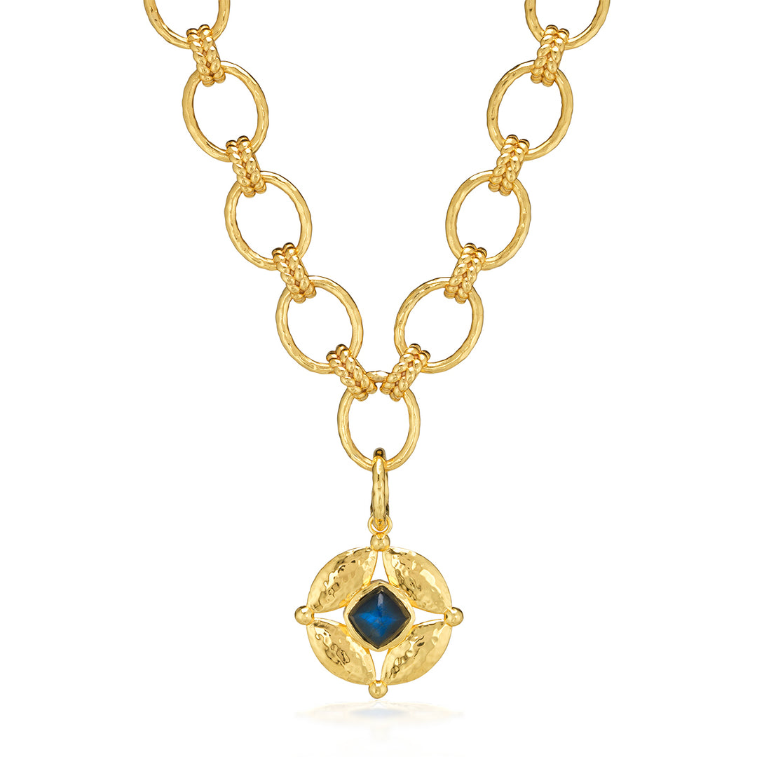 Gold necklace with a blue gemstone pendant 