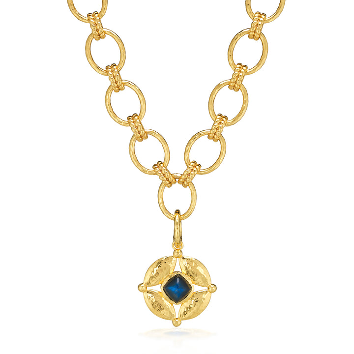Gold necklace with a blue gemstone pendant 