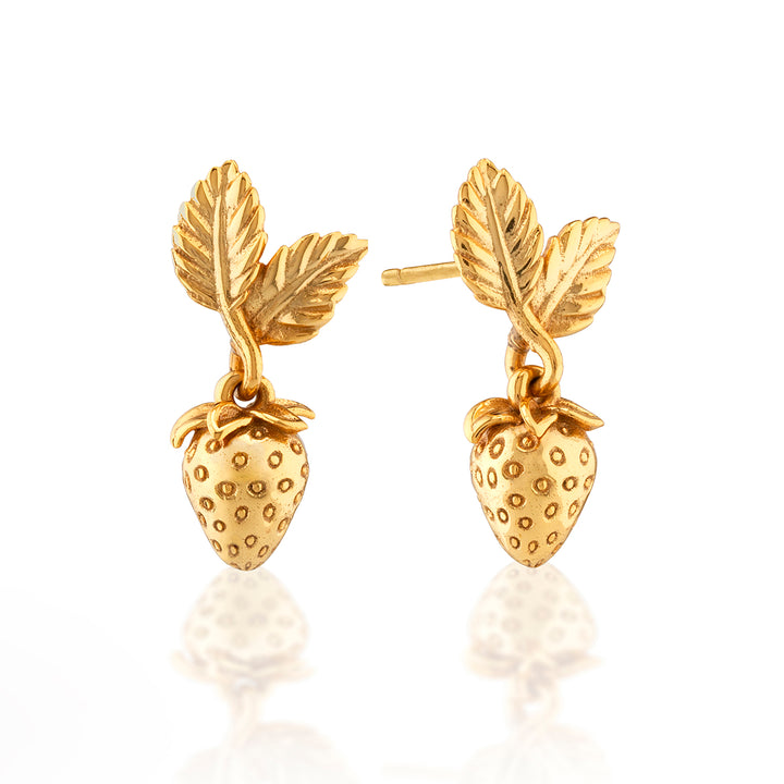 Gold strawberry-shaped earrings with leaf details on a white background