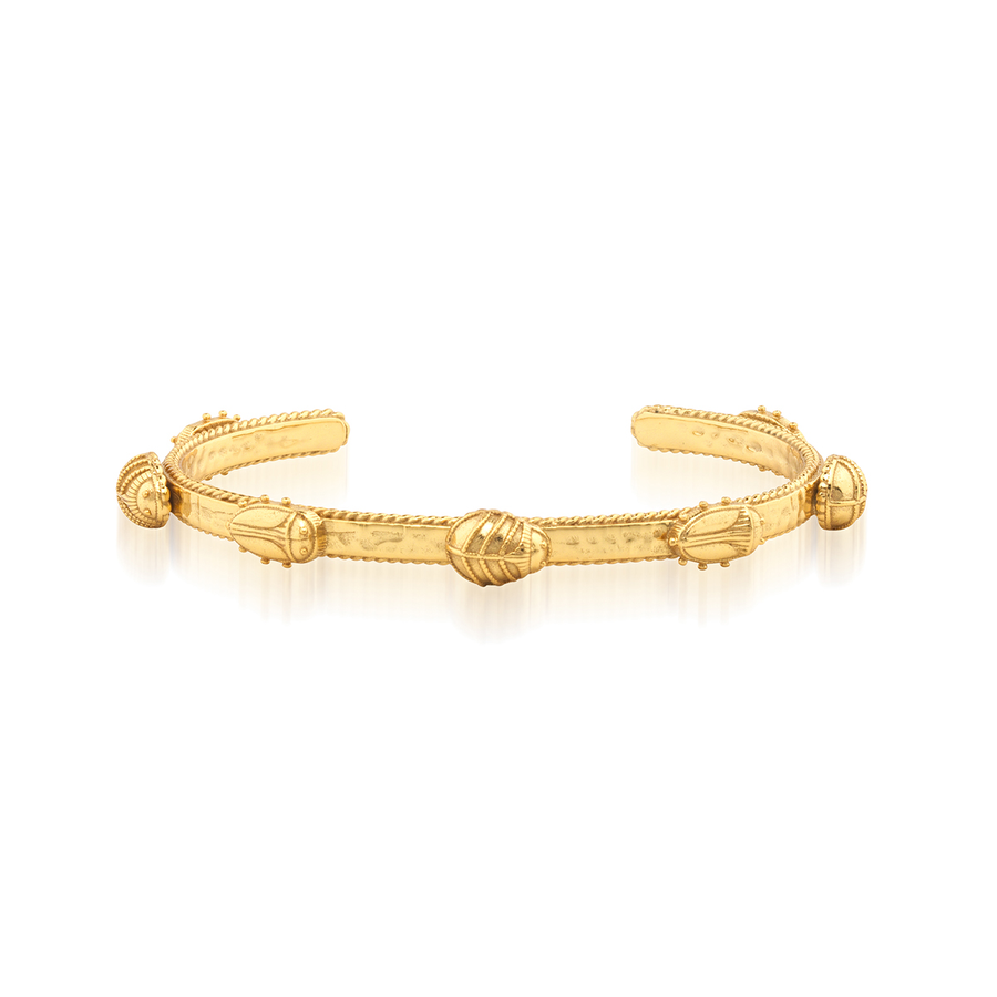 Gold bracelet with gold beetle designs on a white background