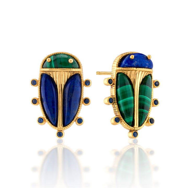 Pair of gold earrings with blue and green scarab beetle gemstones on a white background