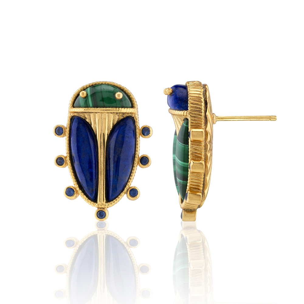 Gold earrings with blue and green scarab beetle gemstones on a white background