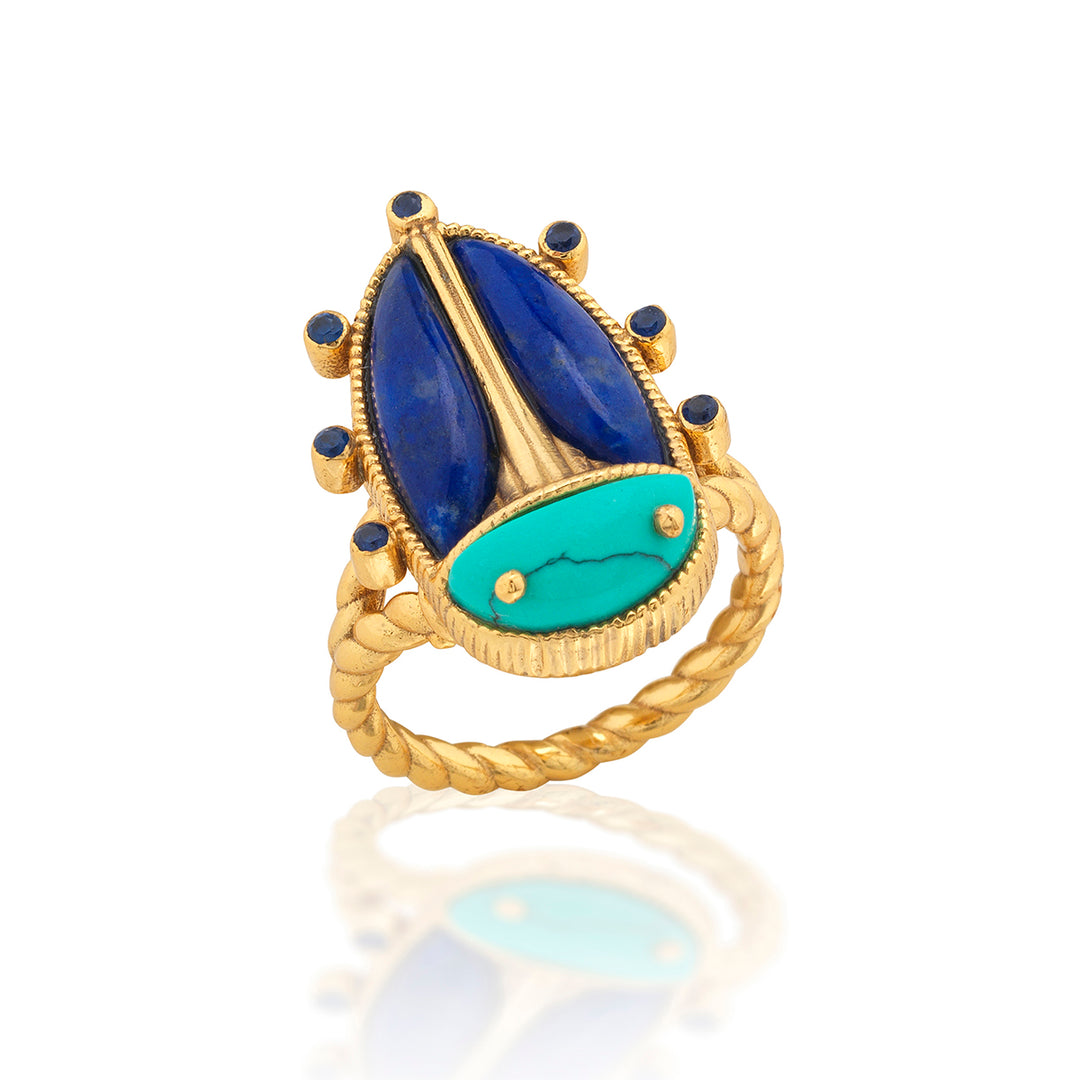 Gold beetle shaped ring with blue and green stones on 