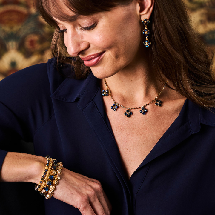 Woman wearing a deep blue labradorite necklace and bracelet 