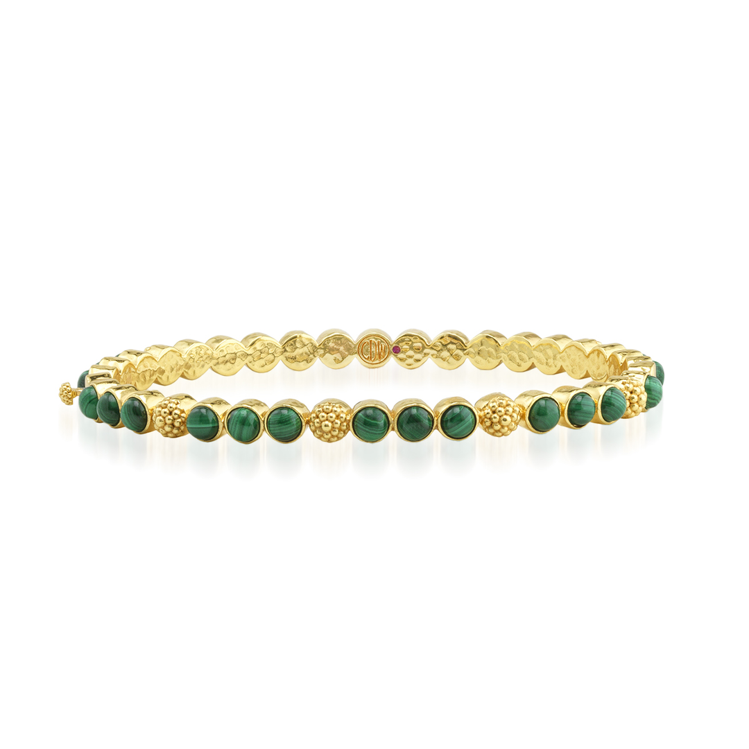Gold bracelet with green gemstones 