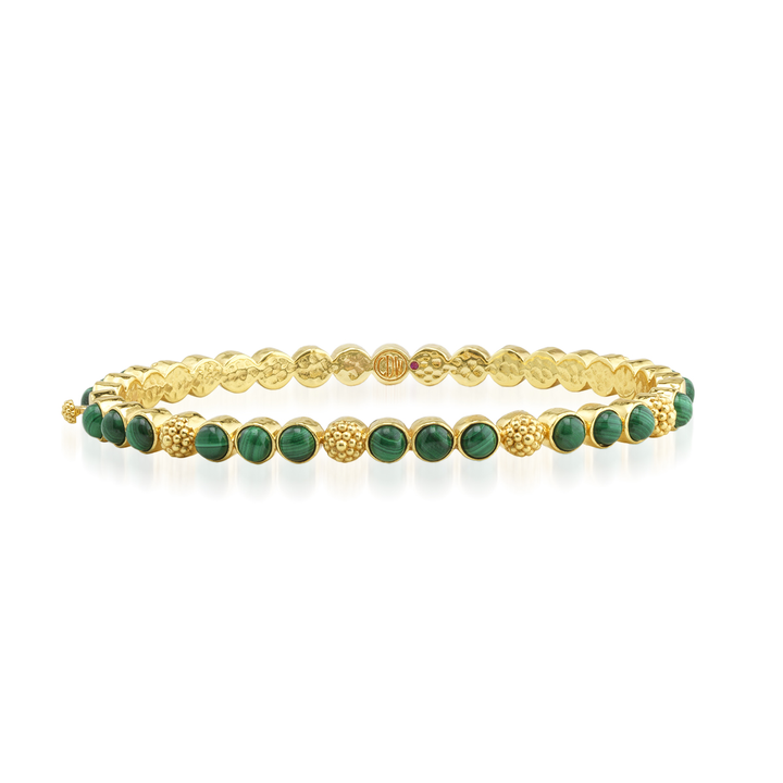 Gold bracelet with green gemstones 