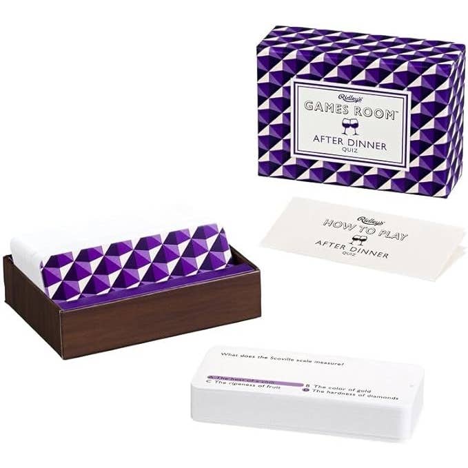 Purple and white geometric patterned box with a card and additional packaging on a white background