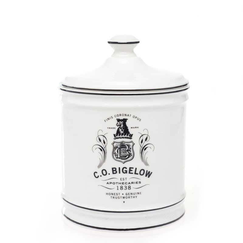 short white CO Bigelow lidded container with black text reading "finis coronat opus, trademark CO Bigelow Apothecaries est 1838" 