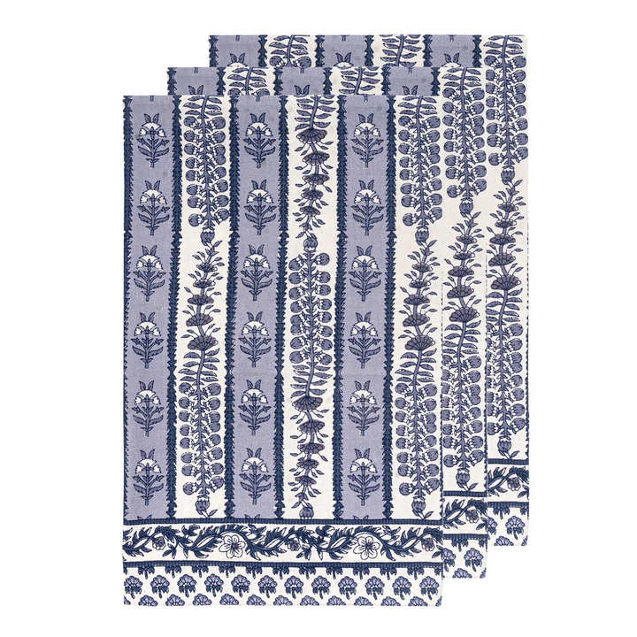 Set of blue and white patterned tea towels on a white background