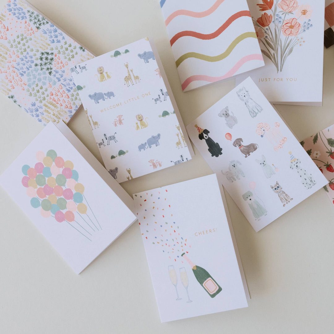 Collection of small greeting cards with various designs on a light surface