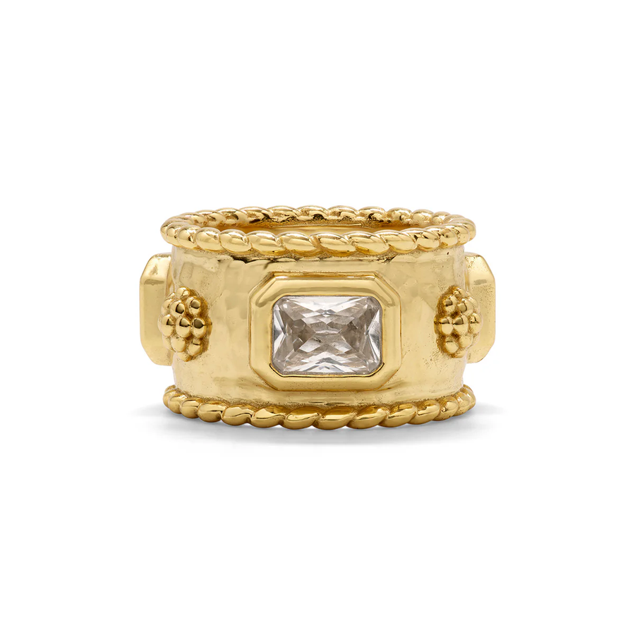 Gold ring with a clear gemstone and berry accents on a white background
