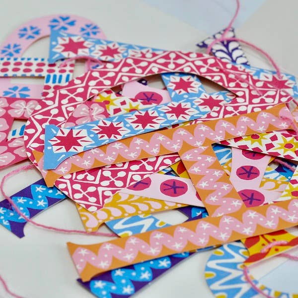 Colorful patterned paper letter cutouts for a happy birthday banner