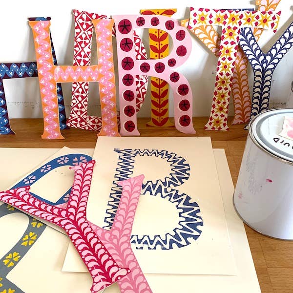 colorful paper cutout letters for a happy burthday banner