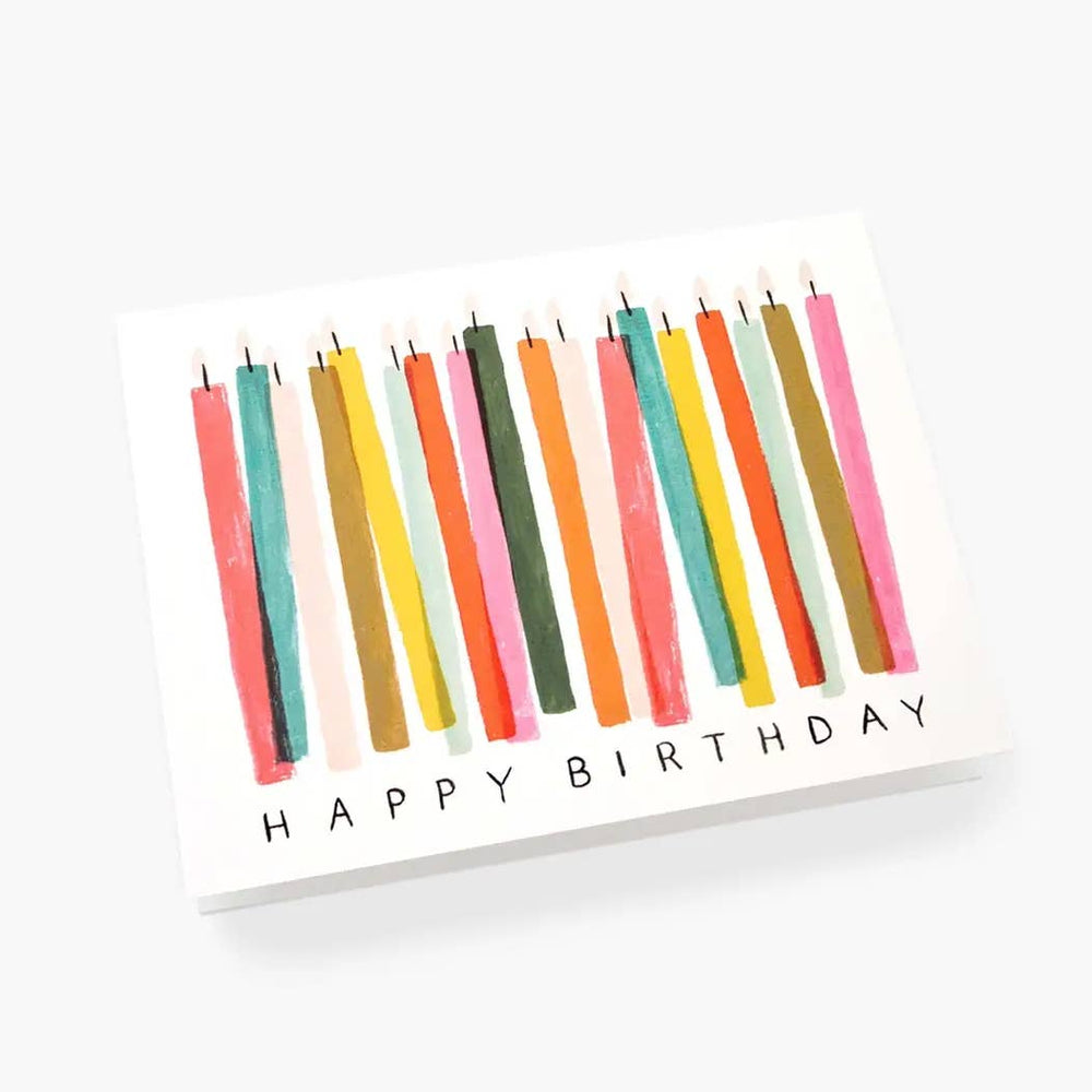 Greeting card with colorful candles and 'Happy Birthday' text on white paper