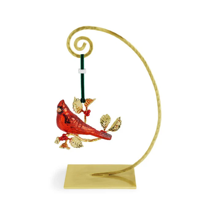 Decorative cardinal ornament on a gold stand with a white background