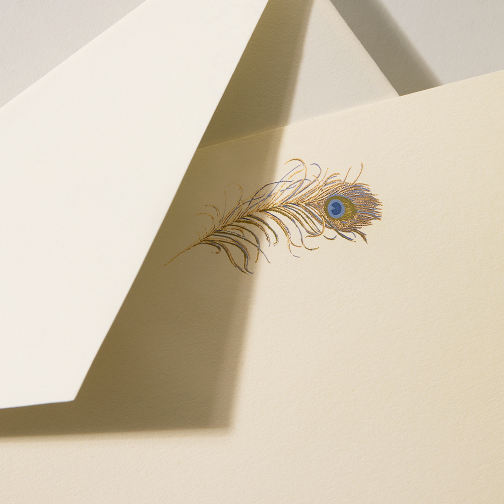 Peacock feather on an ecru card with an ecruwhite envelope