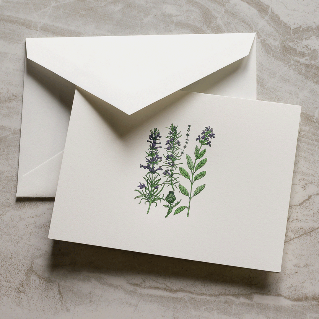 White card with botanical design and matching envelope on a textured surface