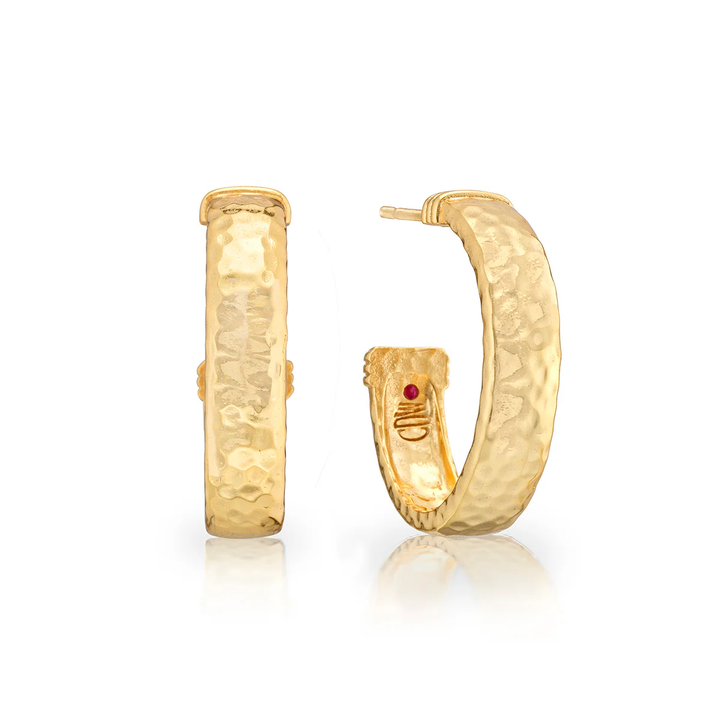 Gold hoop earrings with a hammered texture and a small red gem 