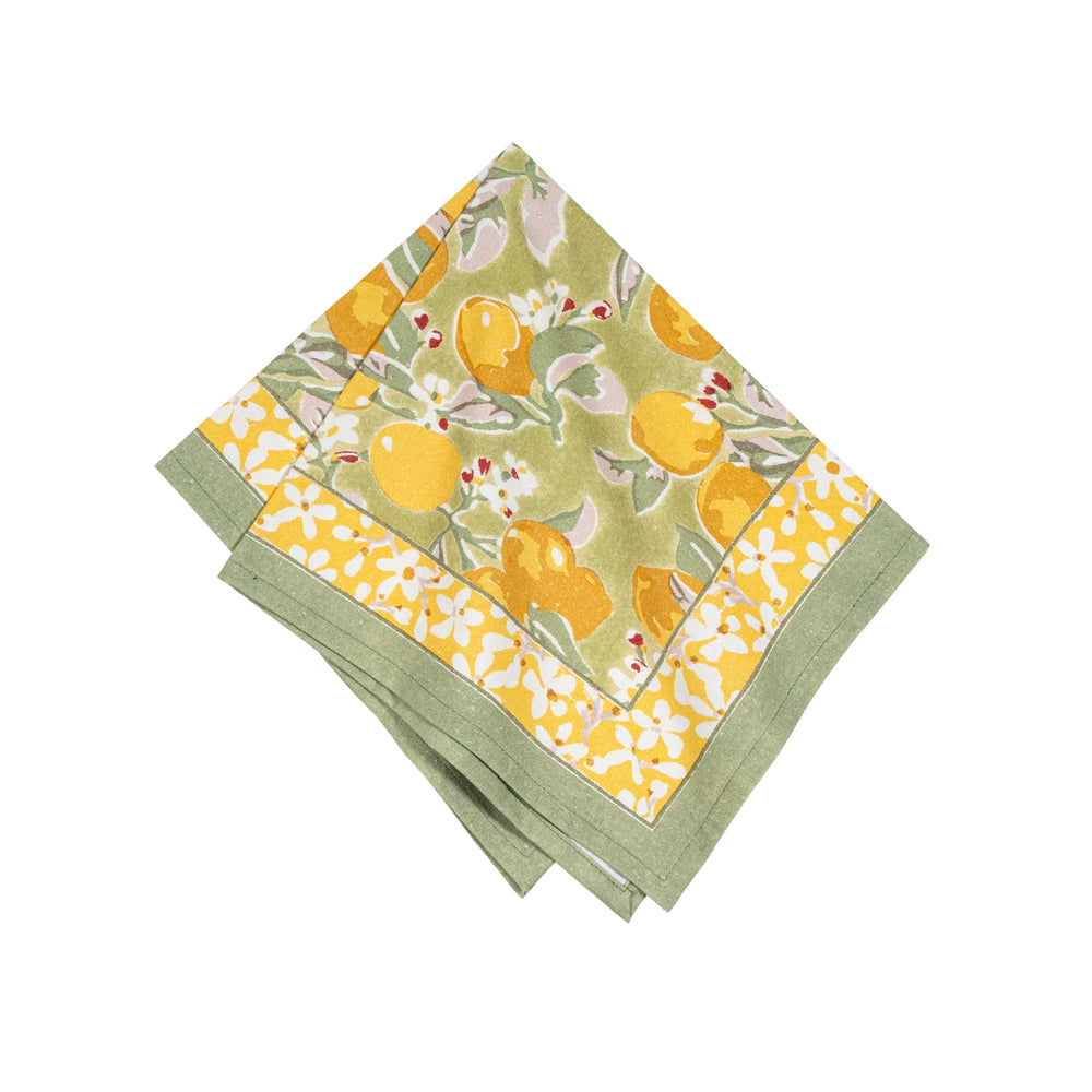 A pair of folded cloth napkins with a green and yellow floral pattern on a blue background, likely made from linen.