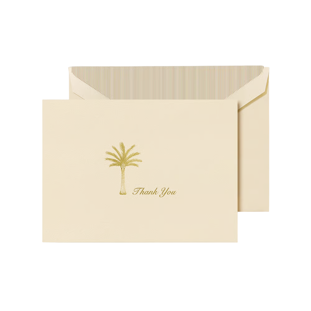 Ecru folded card with gold palm tree design and 'Thank You' text, paired with a matching envelope with a gold striped liner 