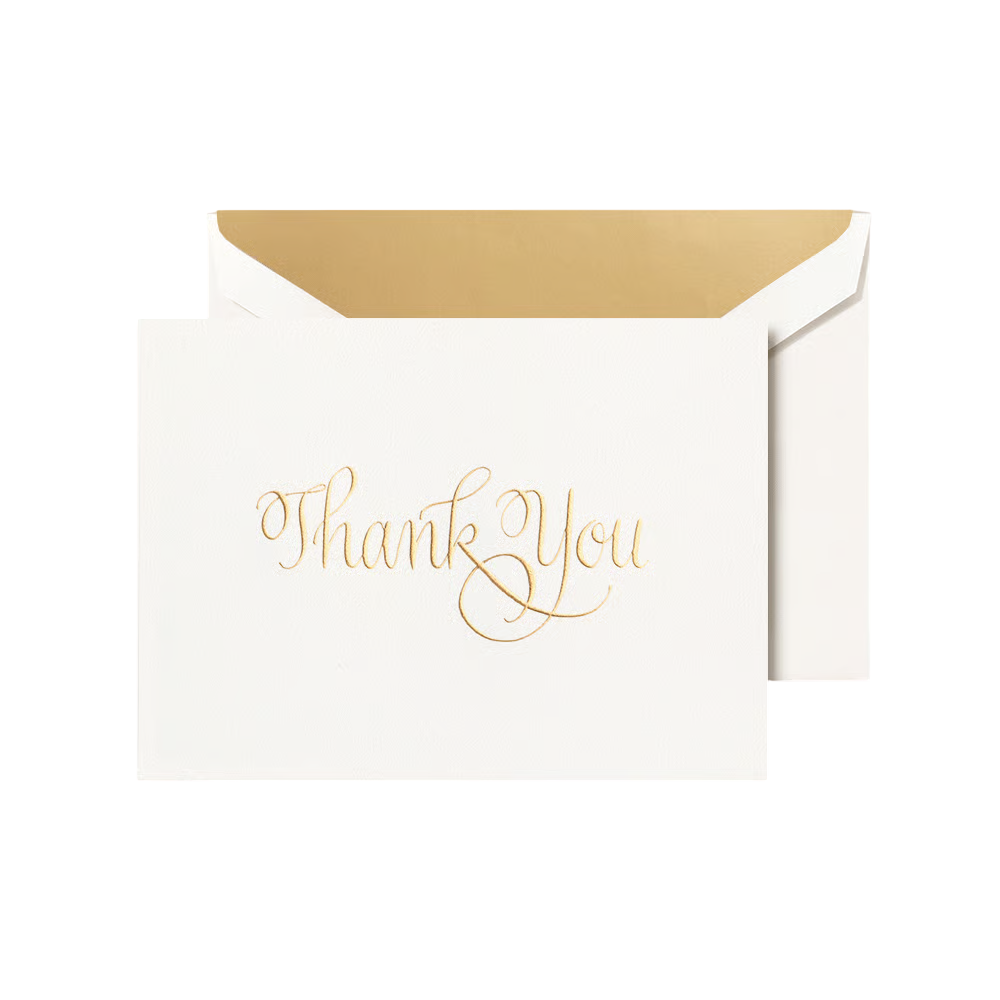 White card with 'Thank You' in gold script engraved on a white envelope with a gold shimmer liner