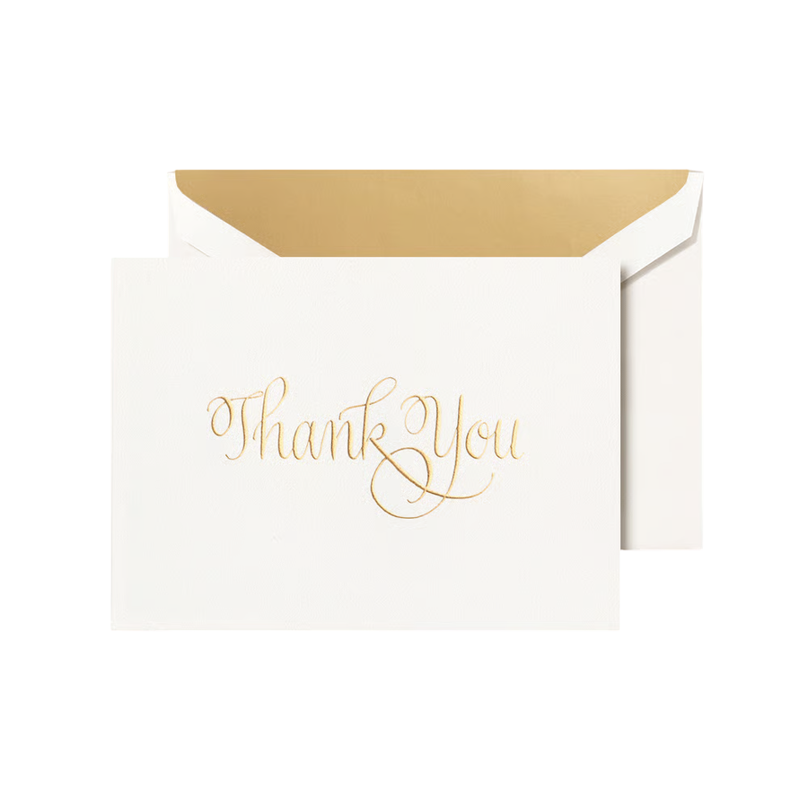 White card with 'Thank You' in gold script engraved on a white envelope with a gold shimmer liner