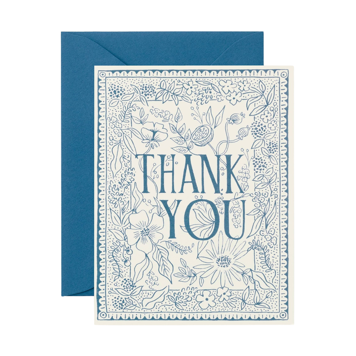 Greeting card with 'Thank You' text and a blue floral design on white paper  and a blue envelope