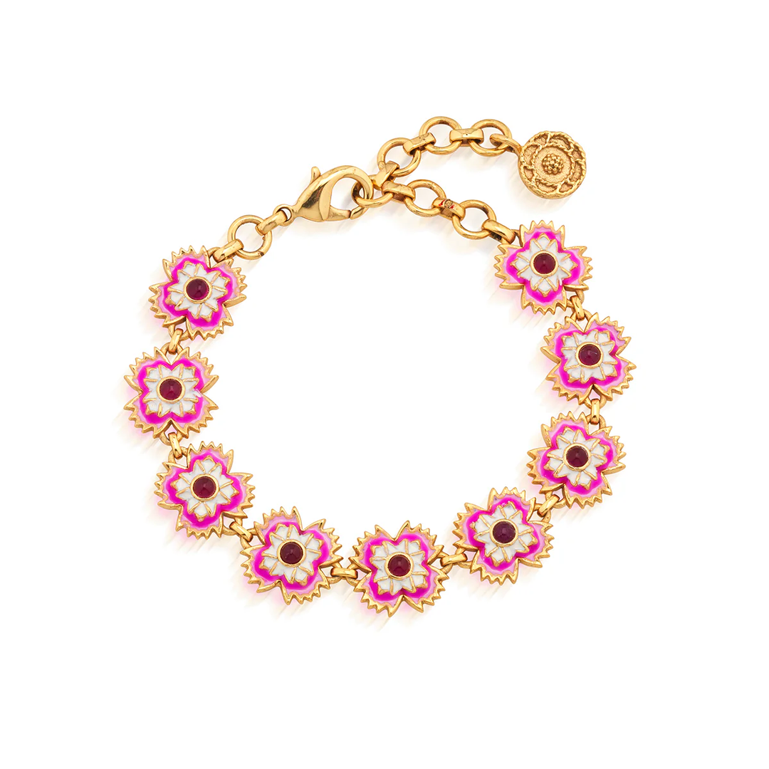 Gold bracelet with pink floral links on a white background